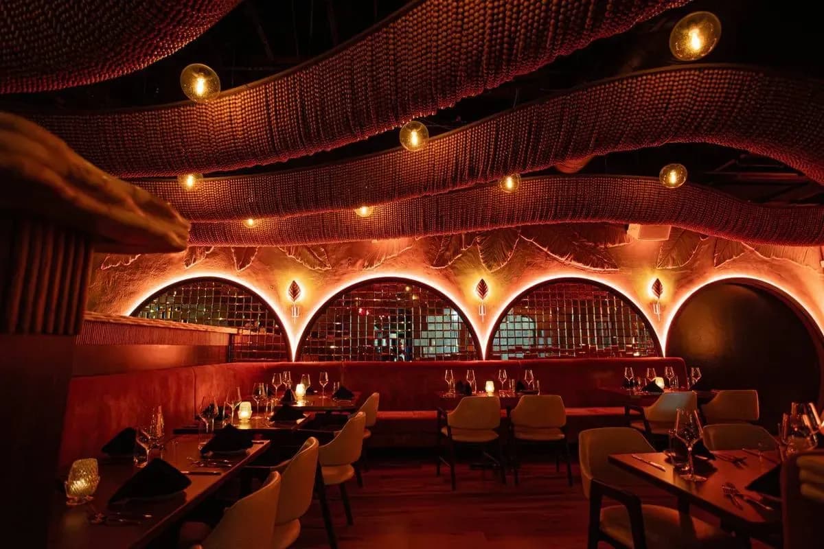 The upper dining room beneath sculptural red arches